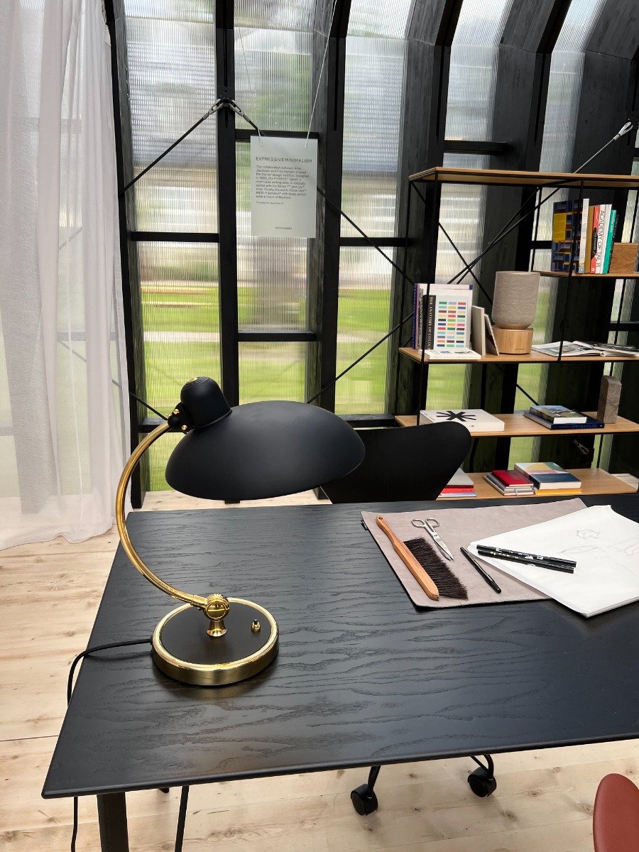 Fritz Hansen Kaiser Idell table lamp sat on a working desk