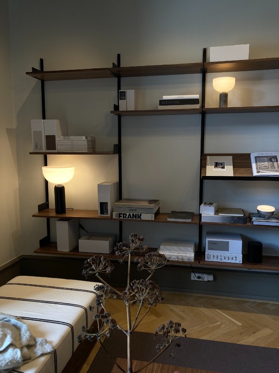 wall of creating shelving featuring Kizu lamps and books