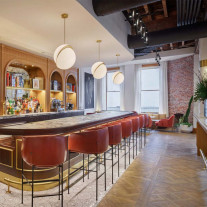 Lee Broom Crescent Pendants Over a Bar