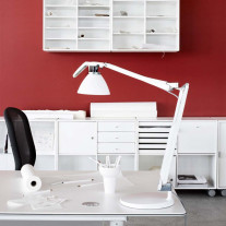 White Luceplan Fortebraccio Table Lamp on a Desk