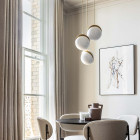 Lee Broom Mini Crescent 3 Piece Chandelier Over a Dining Table