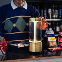 Brass Buster + Punch Takeout LED Portable Lamp on Shop Counter